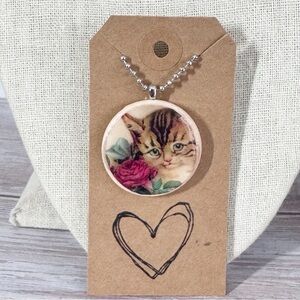 Round wood dimensional artisan cat pendant necklace 
22” stainless steel